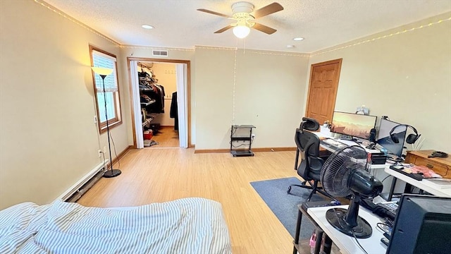 67 Amherst Rd Unit 67, South Hadley, MA 01075 - office area featuring ceiling fan, light wood-style flooring, ornamental molding, a baseboard heating unit, and a textured ceiling