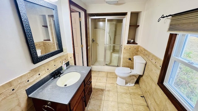 67 Amherst Rd Unit 67, South Hadley, MA 01075 - bathroom featuring a shower stall, tile walls, vanity, a wainscoted wall, and built in features
