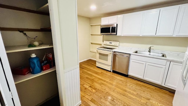 67 Amherst Rd Unit 67, South Hadley, MA 01075 - kitchen with appliances with stainless steel finishes, light wood finished floors, white cabinets, and open shelves