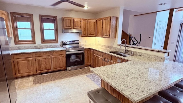 67 Amherst Rd Unit 67, South Hadley, MA 01075 - kitchen featuring stainless steel electric range, a peninsula, under cabinet range hood, and a breakfast bar area