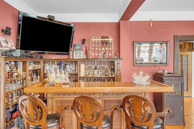 bar featuring parquet floors and ornamental molding