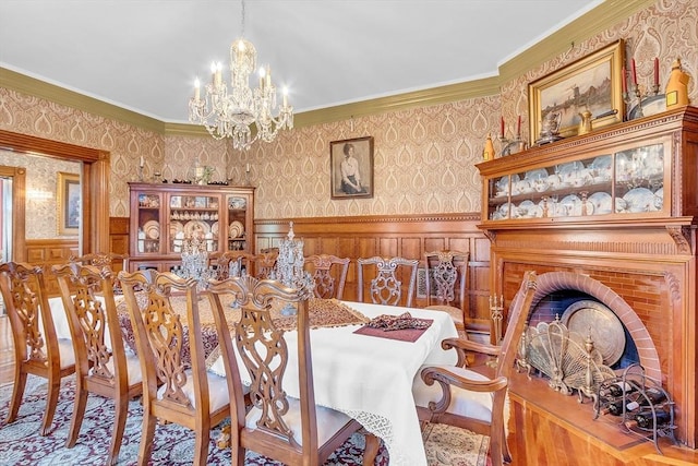 dining area with ornamental molding and an inviting chandelier