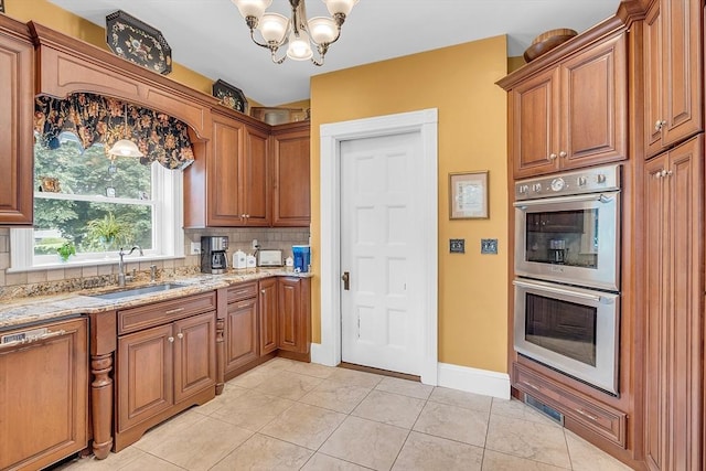 kitchen featuring dishwashing machine, sink, backsplash, light tile patterned flooring, and stainless steel double oven