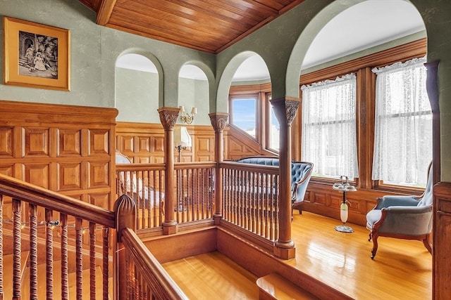 interior space with crown molding, hardwood / wood-style floors, and wood ceiling