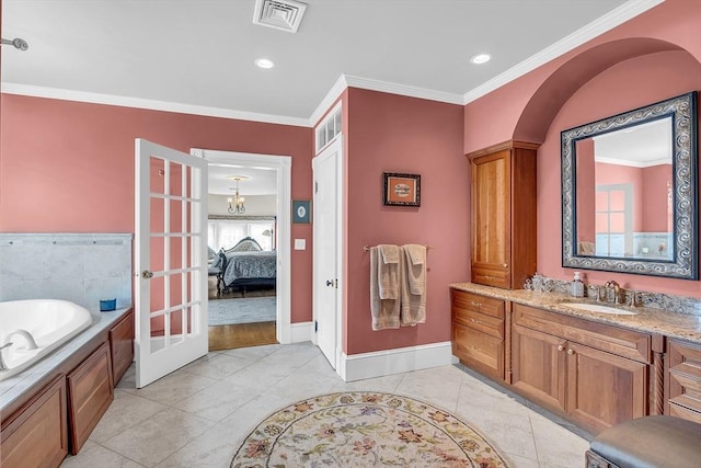 bathroom featuring french doors, tile patterned floors, ornamental molding, vanity, and a bathtub