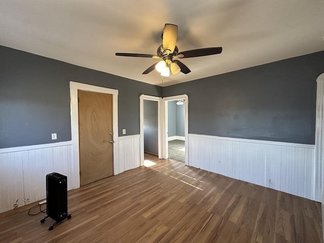 unfurnished room featuring hardwood / wood-style flooring and ceiling fan