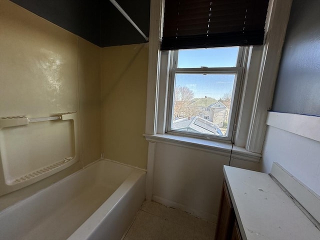 bathroom with tile patterned floors and a bathtub