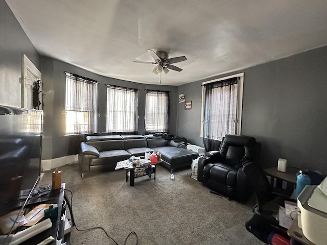 living room with ceiling fan and carpet