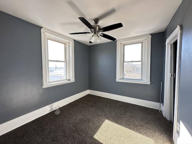 empty room with ceiling fan and plenty of natural light