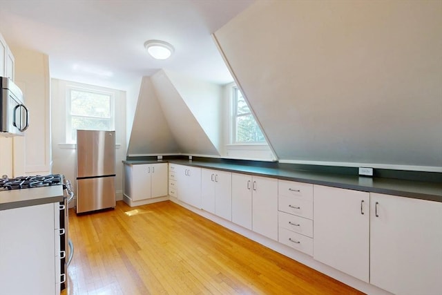 12 Bigelow Cir Unit 3, Boston, MA 02135 - bonus room featuring light wood-style flooring, healthy amount of natural light, and vaulted ceiling