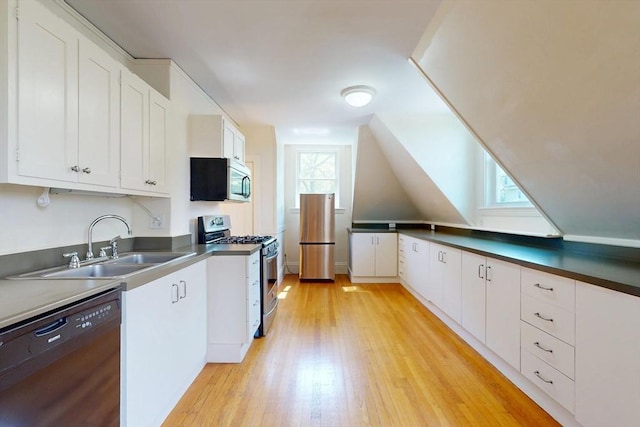 12 Bigelow Cir Unit 3, Boston, MA 02135 - kitchen with stainless steel appliances, light wood-style flooring, white cabinetry, and dark countertops