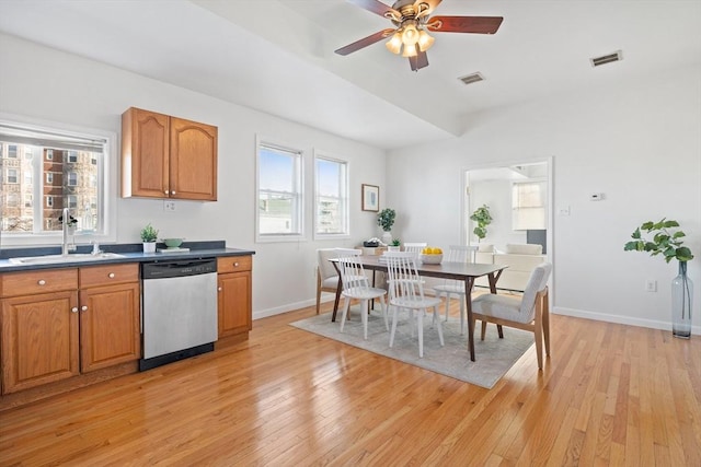 kitchen with stainless steel dishwasher, ceiling fan, light wood-type flooring, and sink