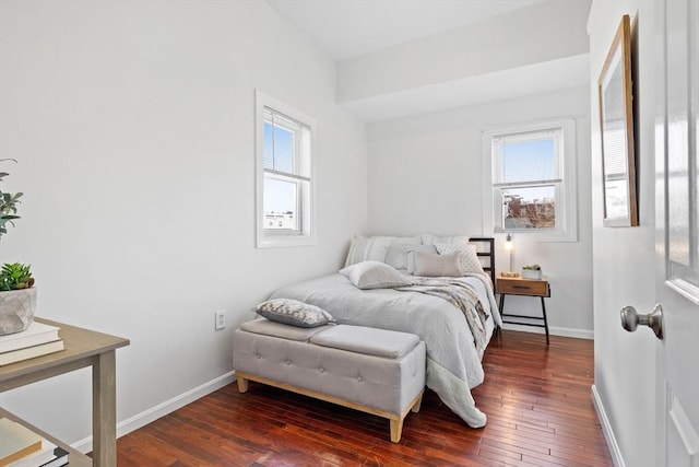 bedroom with dark wood-type flooring