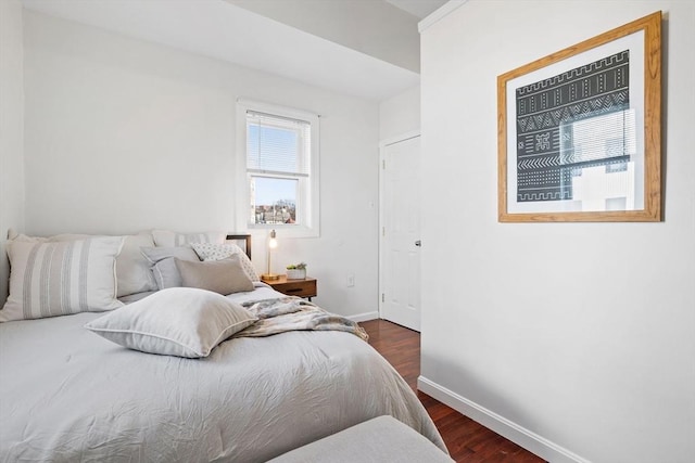 bedroom with dark hardwood / wood-style floors