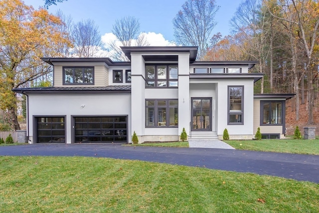 view of front of property with a garage and a front yard