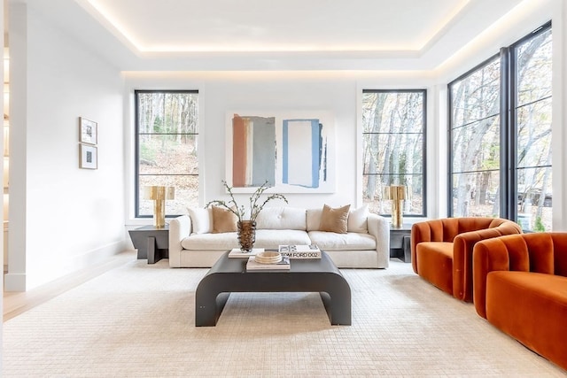 living area with a wealth of natural light and light colored carpet