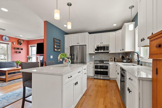4 Curley Cir, Ayer, MA 01432 - kitchen with a sink, light wood finished floors, a healthy amount of sunlight, and stainless steel appliances