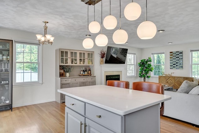 7 Sequoia Dr, Wilmington, MA 01887 - kitchen featuring open floor plan, plenty of natural light, light wood-type flooring, a fireplace, and a textured ceiling