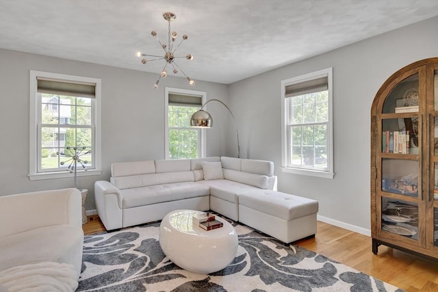 7 Sequoia Dr, Wilmington, MA 01887 - living room with plenty of natural light, wood finished floors, a chandelier, and baseboards