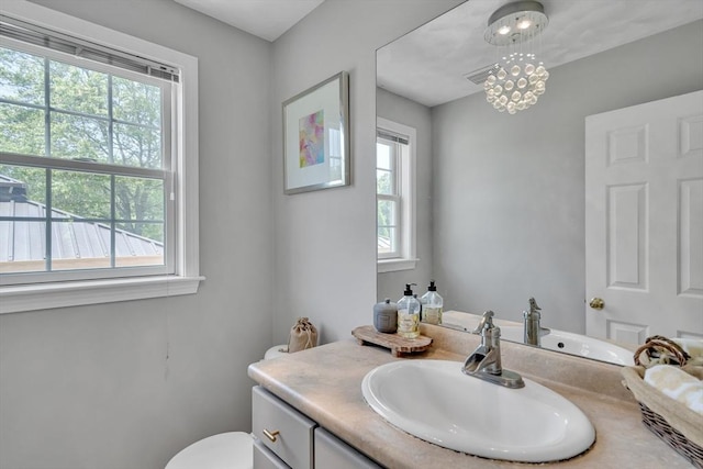 7 Sequoia Dr, Wilmington, MA 01887 - bathroom featuring vanity, toilet, and a chandelier