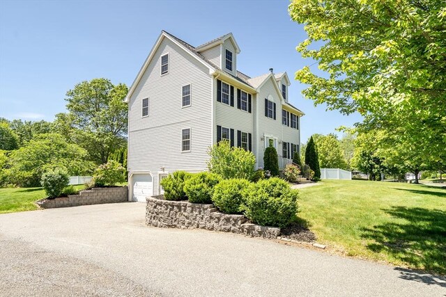 7 Sequoia Dr, Wilmington, MA 01887 - view of side of home with a yard, a garage, and concrete driveway
