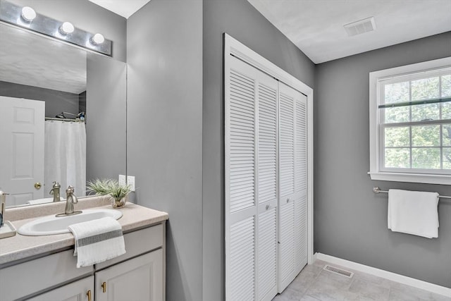 7 Sequoia Dr, Wilmington, MA 01887 - bathroom featuring a closet, vanity, baseboards, and tile patterned floors