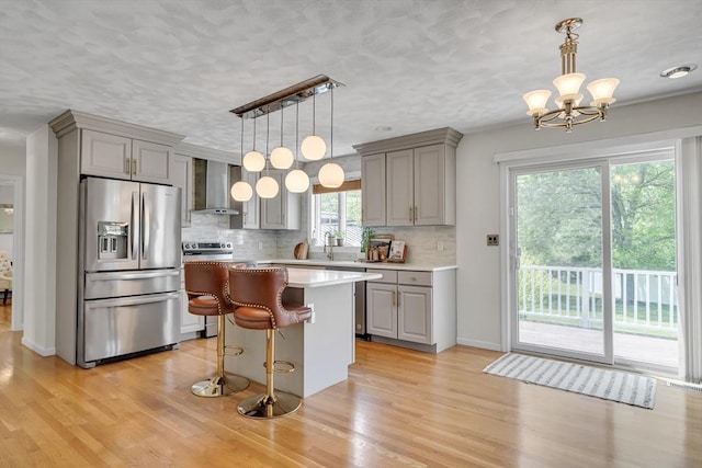 7 Sequoia Dr, Wilmington, MA 01887 - kitchen with stainless steel fridge, gray cabinetry, wall chimney exhaust hood, light countertops, and a textured ceiling