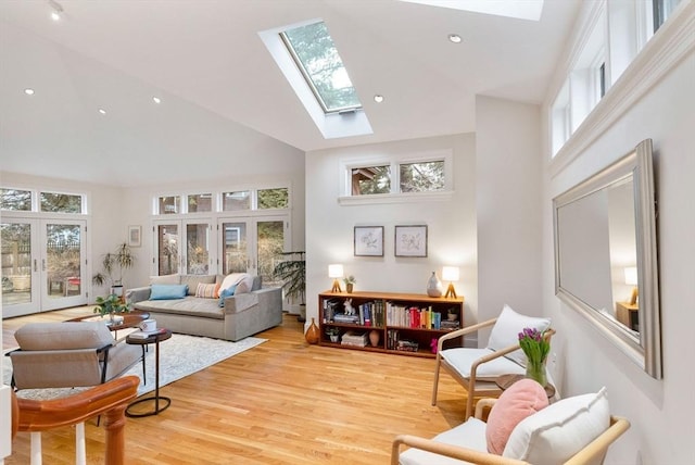 living area featuring plenty of natural light, french doors, and high vaulted ceiling