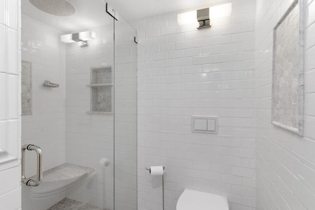 bathroom featuring a shower stall and toilet