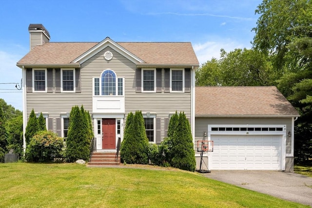 3 42nd St, Berkley, MA 02779 - colonial house featuring driveway, a front yard, a chimney, a shingled roof, and a garage