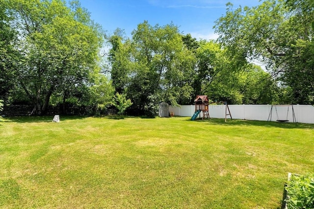 3 42nd St, Berkley, MA 02779 - fenced backyard featuring a playground and view of scattered trees