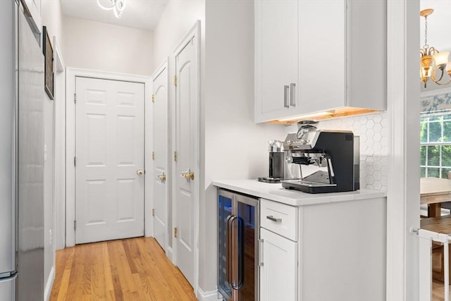 3 42nd St, Berkley, MA 02779 - bar with beverage cooler, light wood-style floors, a chandelier, and pendant lighting