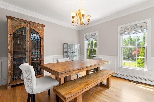 3 42nd St, Berkley, MA 02779 - dining area featuring a chandelier, wainscoting, light wood-style floors, a decorative wall, and crown molding