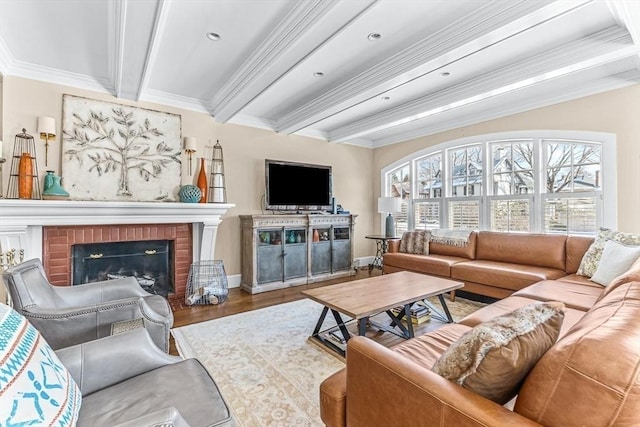 living area featuring a wealth of natural light, a fireplace, wood finished floors, and beam ceiling