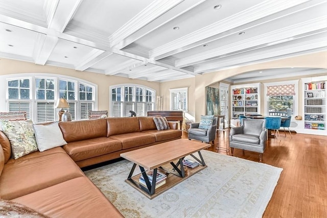 living room with a wealth of natural light, light wood-style flooring, coffered ceiling, and beam ceiling