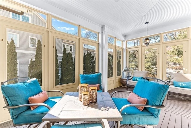 sunroom featuring lofted ceiling and a wealth of natural light