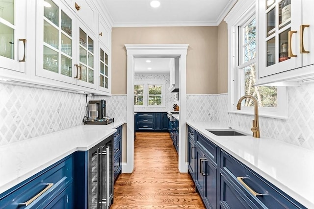 kitchen featuring glass insert cabinets, light countertops, white cabinetry, and blue cabinets