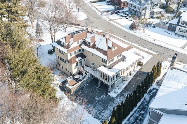 snowy aerial view featuring a residential view