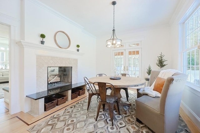 dining area with plenty of natural light, a fireplace, and light hardwood / wood-style floors