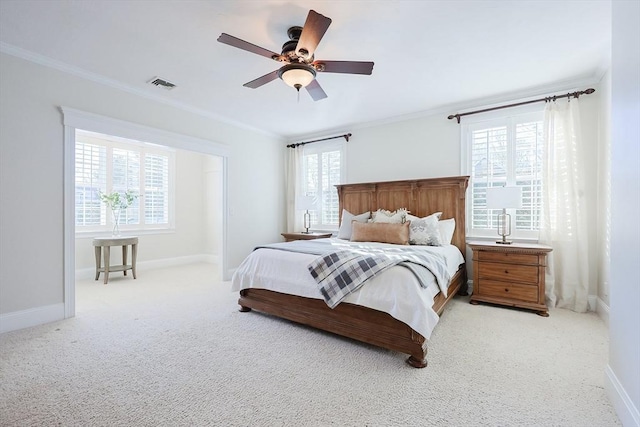 carpeted bedroom featuring multiple windows, crown molding, and ceiling fan