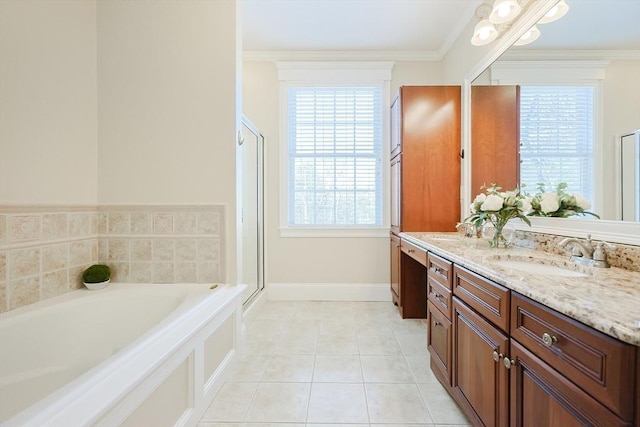 bathroom with tile patterned flooring, crown molding, shower with separate bathtub, and vanity