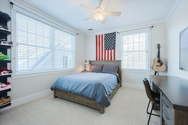 bedroom with ceiling fan, ornamental molding, and carpet flooring