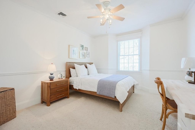 bedroom featuring ornamental molding, light colored carpet, and ceiling fan