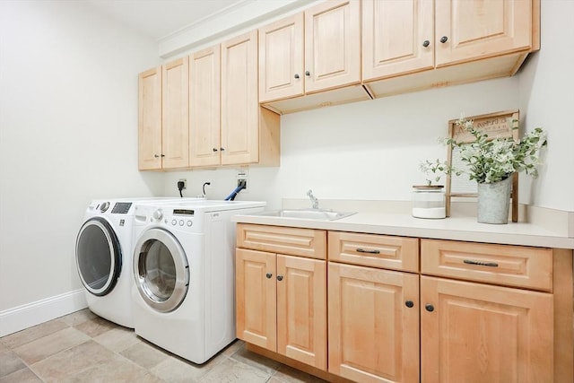 washroom with cabinets, separate washer and dryer, sink, and light tile patterned floors