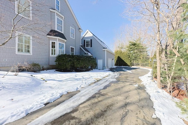 snow covered property featuring a garage