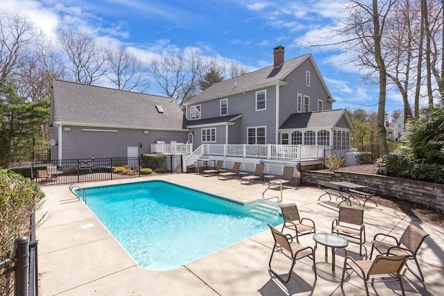 view of swimming pool featuring a deck and a patio area