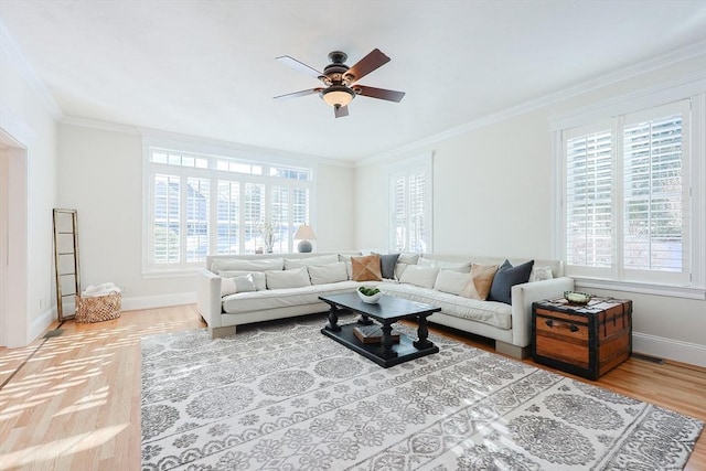 living room featuring crown molding, hardwood / wood-style flooring, a wealth of natural light, and ceiling fan