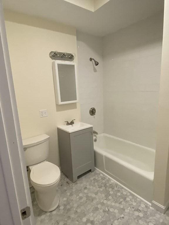 full bathroom with shower / tub combination, vanity, and toilet