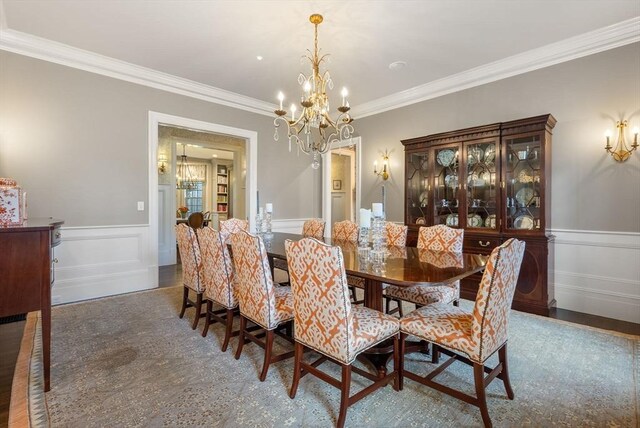 dining area featuring ornamental molding and a chandelier