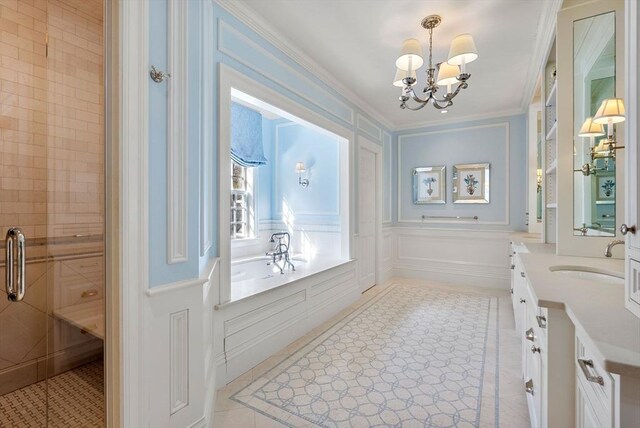 bathroom with crown molding, vanity, a notable chandelier, a shower with shower door, and tile patterned floors